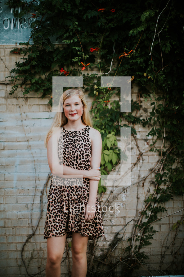 teen girl in a leopard print dress