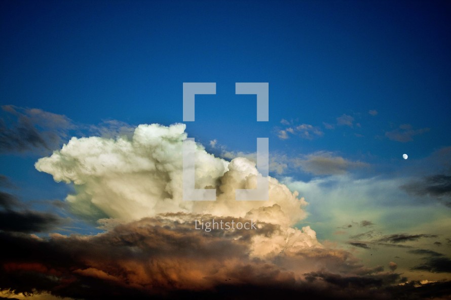 towering clouds in the sky at sunset 