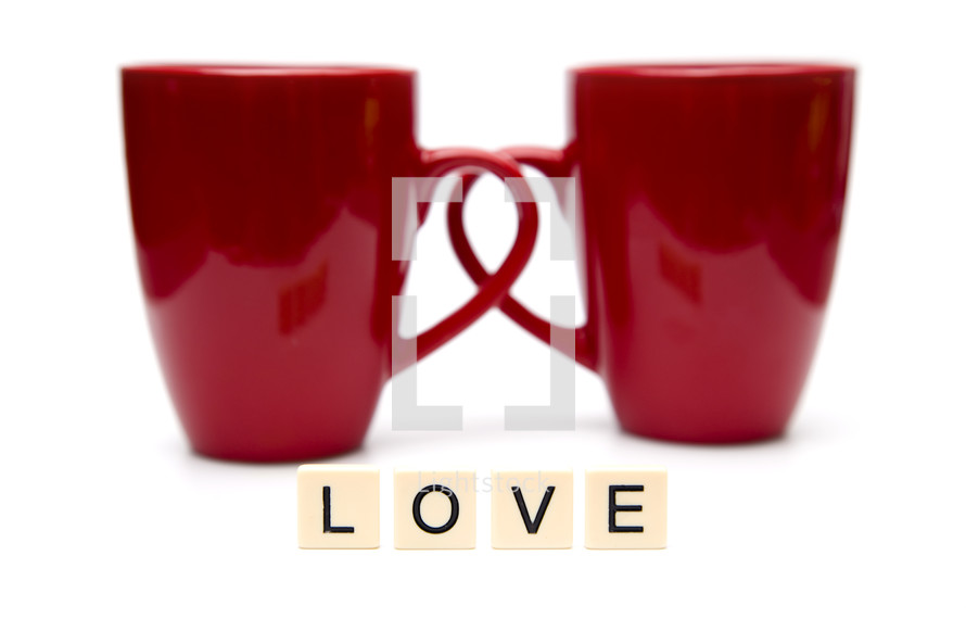 word love and two red coffee mugs 