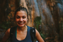 a headshot of a woman who is exploring and backpacking outdoors 