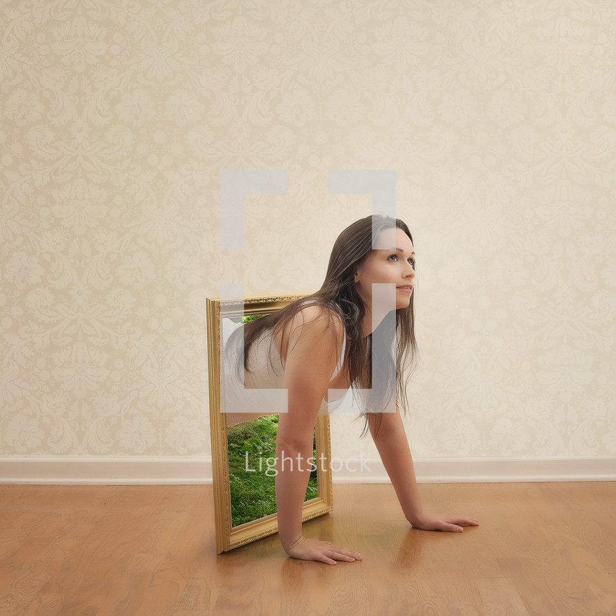woman crawling out of a framed mirror 