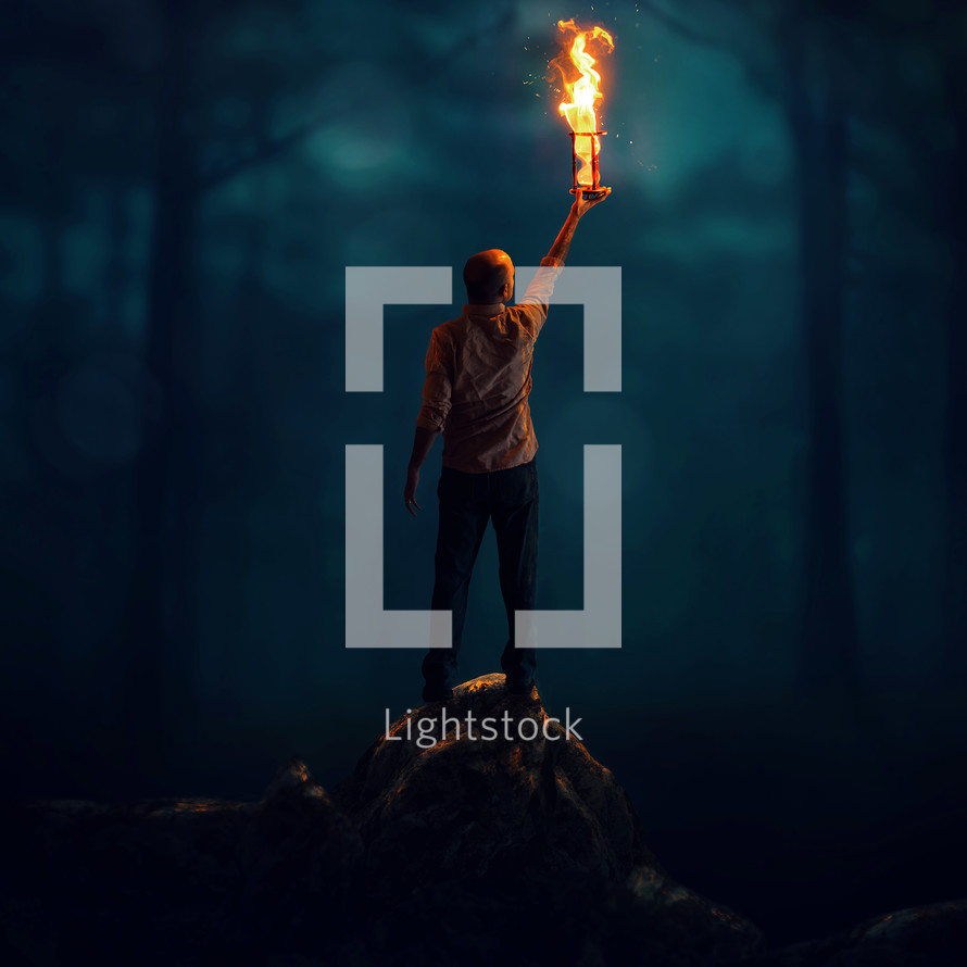 man holding up a flaming hourglass 
