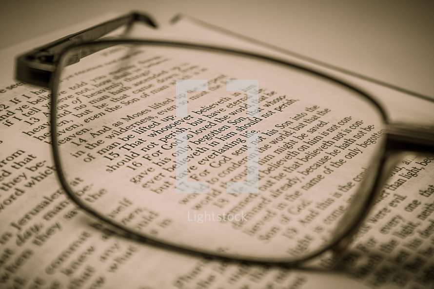 reading glasses on pages of a Bible 