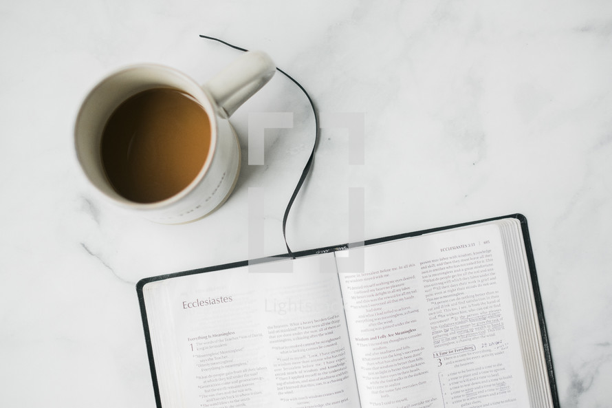 coffee cup and opened Bible 