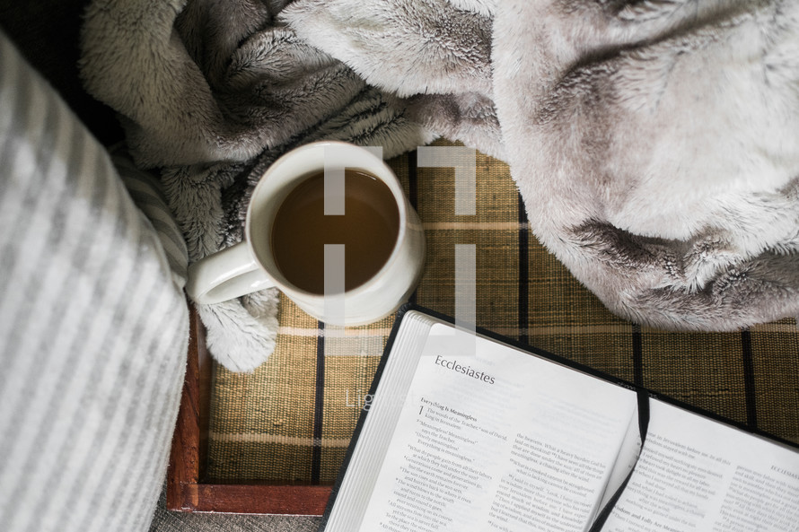 coffee cup and open Bible 
