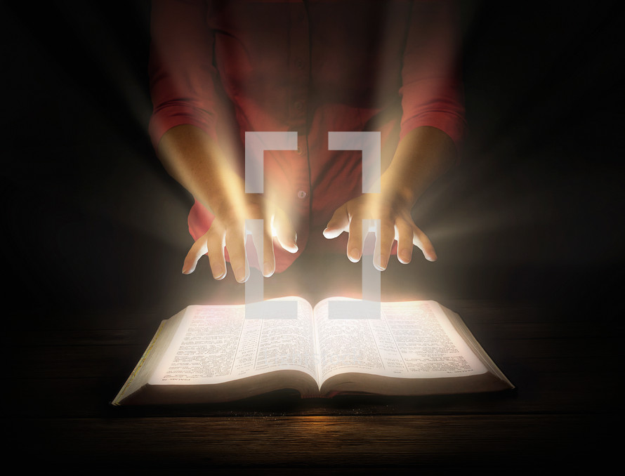 A woman with outstretched hands over an open Bible from which light shines.