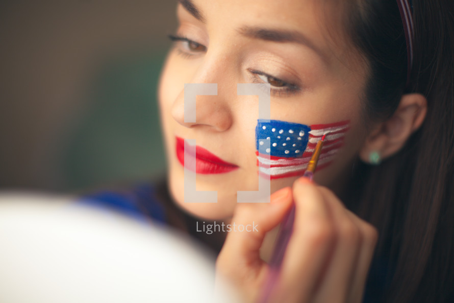 woman with face paint of a flag for July 4th 