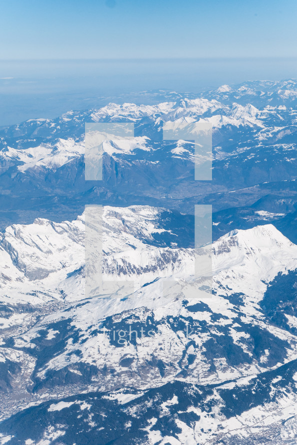 aerial view over snow capped mountains 