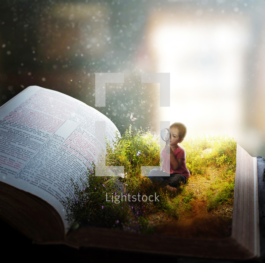 A little girl watches butterflies on the pages of an open Bible