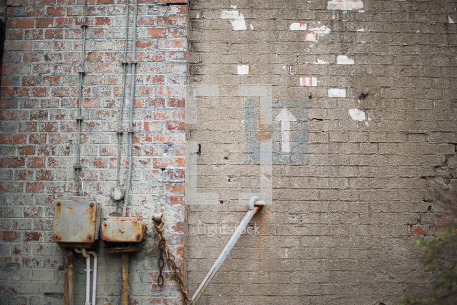 Brick walls with an arrow pointing up.