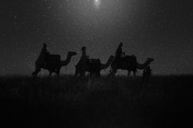 wise men traveling on camels under the stars 