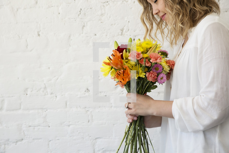 a woman holding a bouquet of flowers 