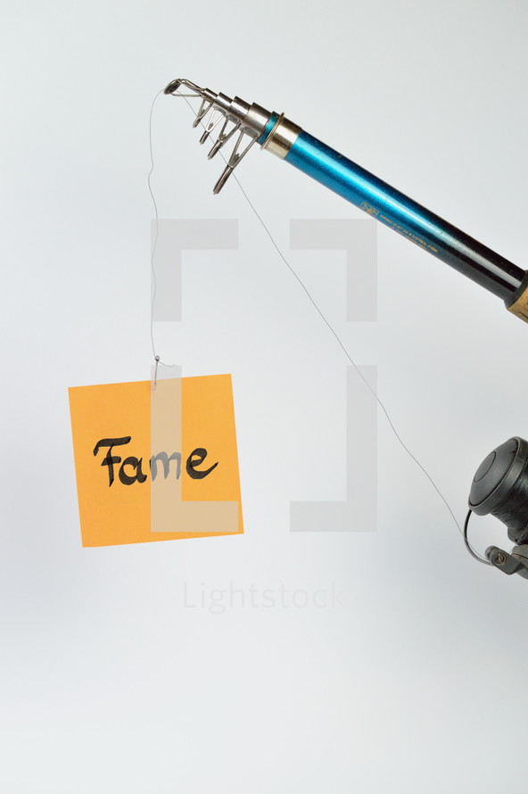 A fishing pole with a piece of paper with the word fame on it 
