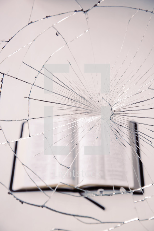 Bible behind cracked glass
