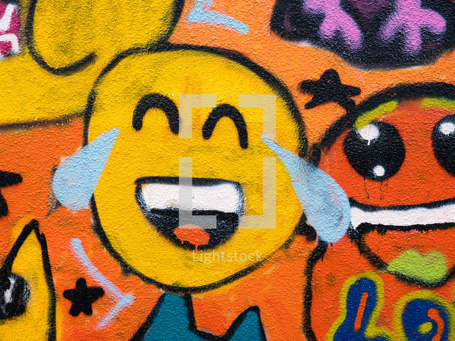 a smiley face emoji graffiti