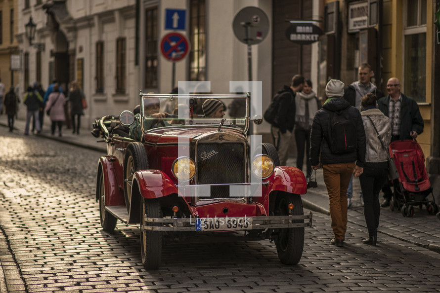vintage car on a cobblestone street 