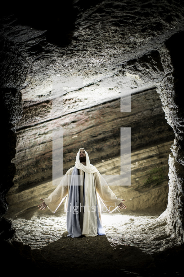 Jesus kneeling in prayer in a tomb