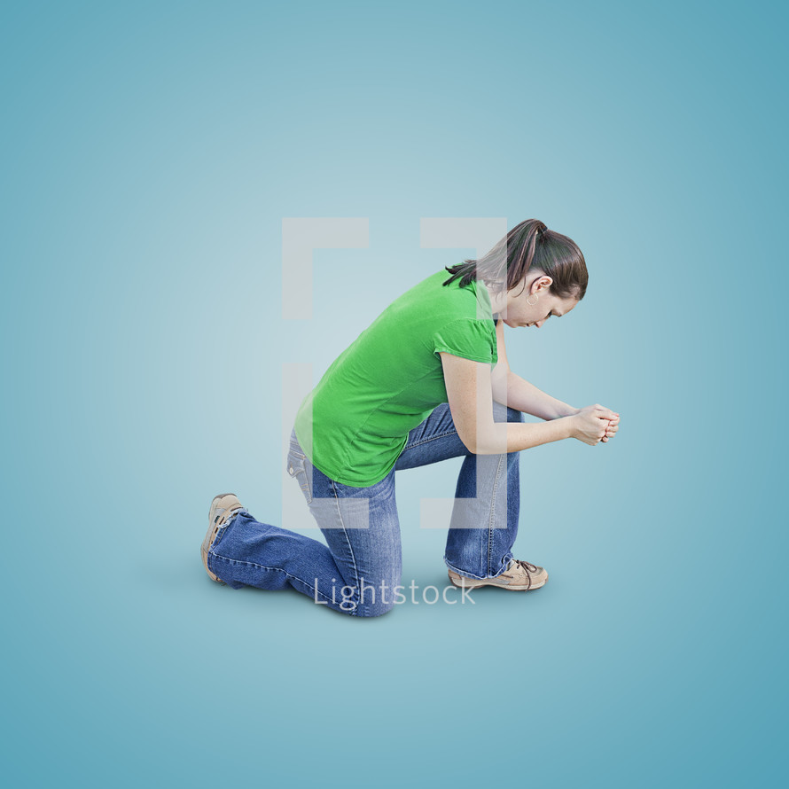 Woman kneeling with elbows resting on her knee in prayer.