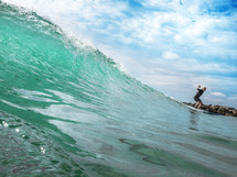 A new surfer rides a wave to shore