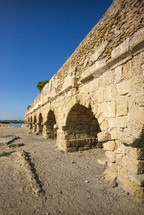 arches on a stone aqueduct outside the Roman city of Caesarea