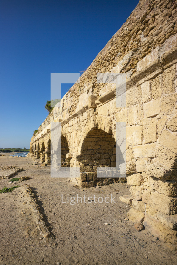 arches on a stone aqueduct outside the Roman city of Caesarea