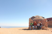 friends posing for a picture at Pike's Peak summit 