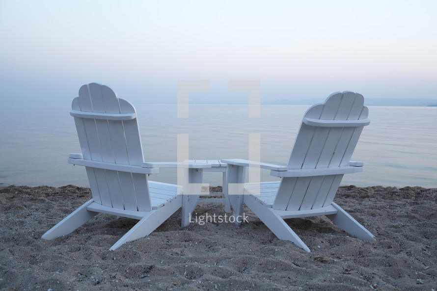 Empty wooden deck chairs on a beach