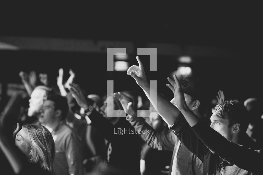 People worshipping Jesus with hands high during worship. 