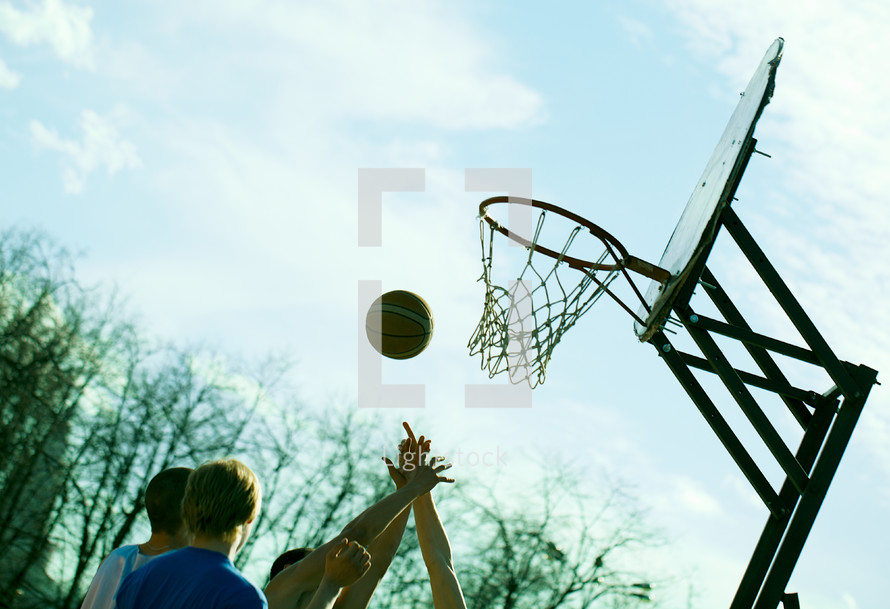 People playing basketball outdoors