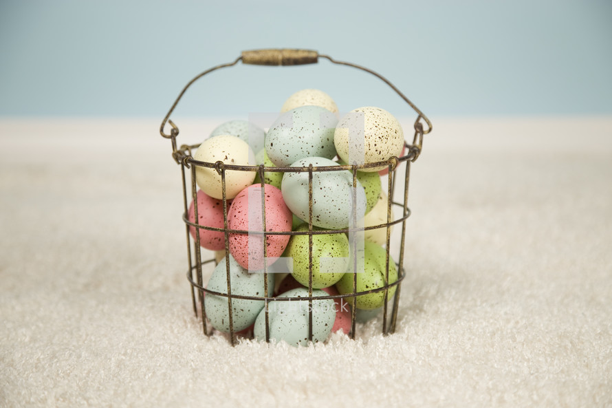 speckled eggs in a wire basket 