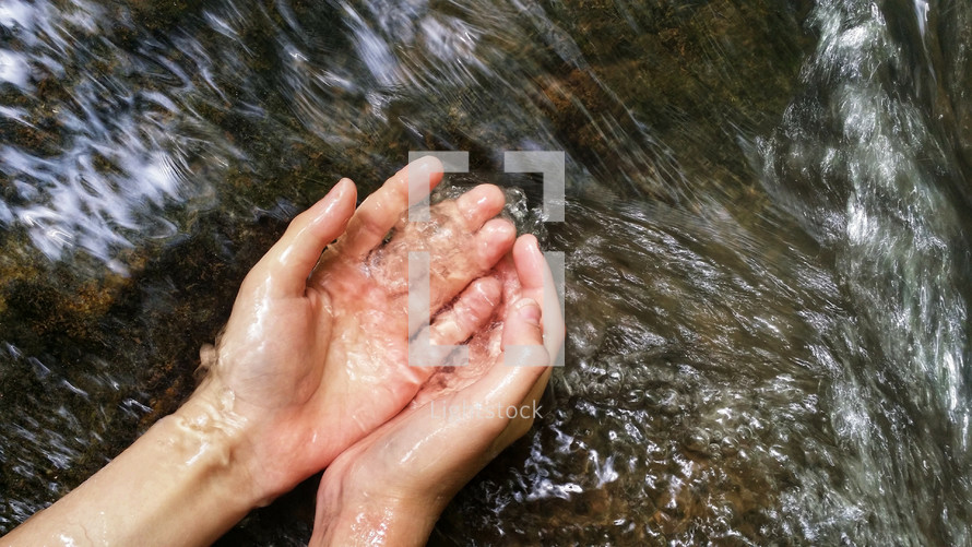 washing hands in a flowing stream 