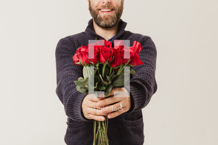 man holding red long stem roses 