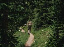 man hiking a forest trail 