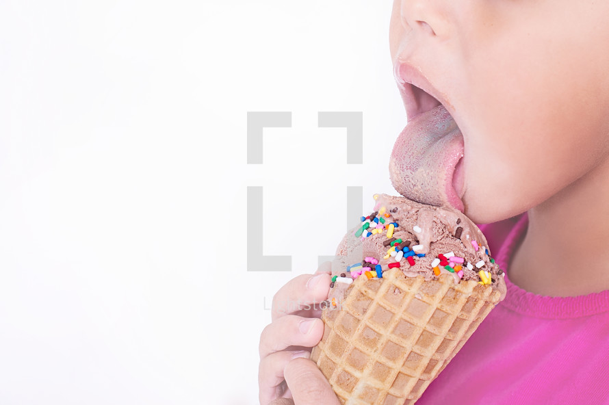 child licking an ice cream cone 