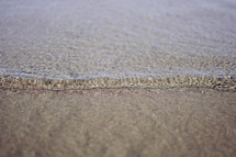 tide washing onto the sand 