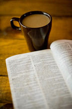 coffee cup and open Bible 