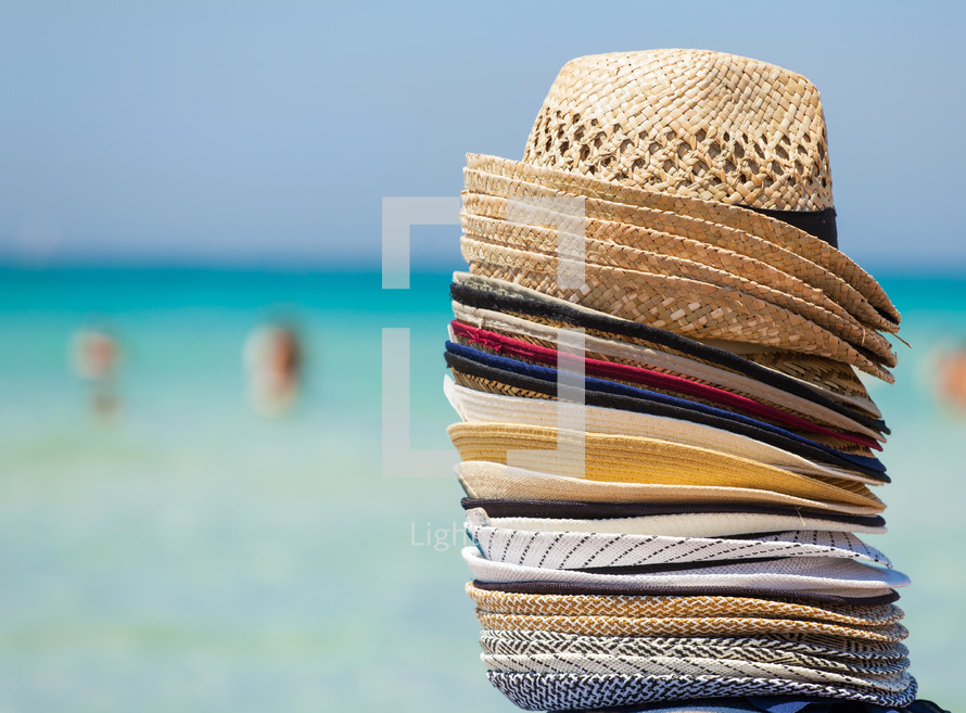 Colorful hats for sale on the beach, travel concept.