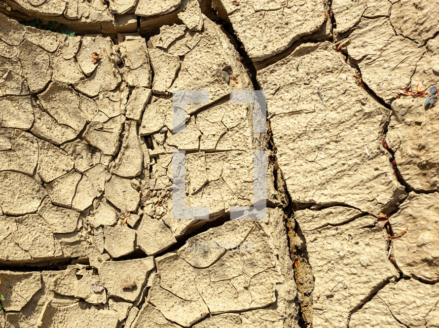 Closeup of dried crack mud representing global warming and climate change.
