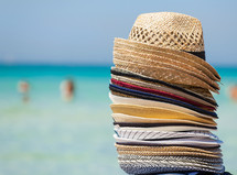 Colorful hats for sale on the beach, travel concept.