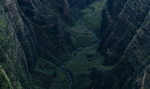 river at the bottom of a green mountain canyon 