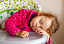 child napping in her highchair 