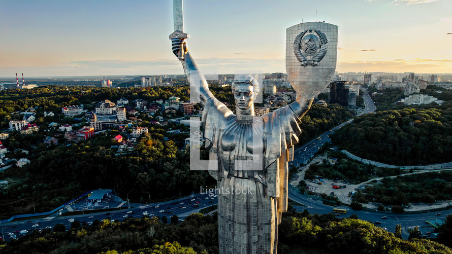 Kyiv, Ukraine - September, 2022: aerial view of Motherland Monument. Drone footage with sun flares. Monumental statue in the capital. One of most important sights of city