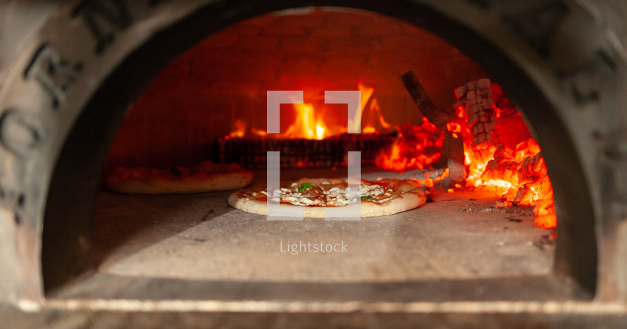 pizza cooking in a pizza oven 