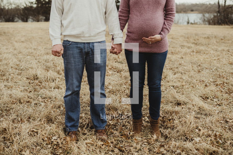 portrait of an expecting couple in fall 