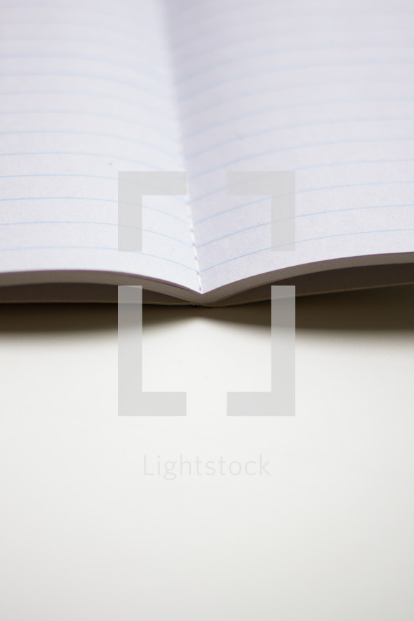 lined paper in an open notebook 