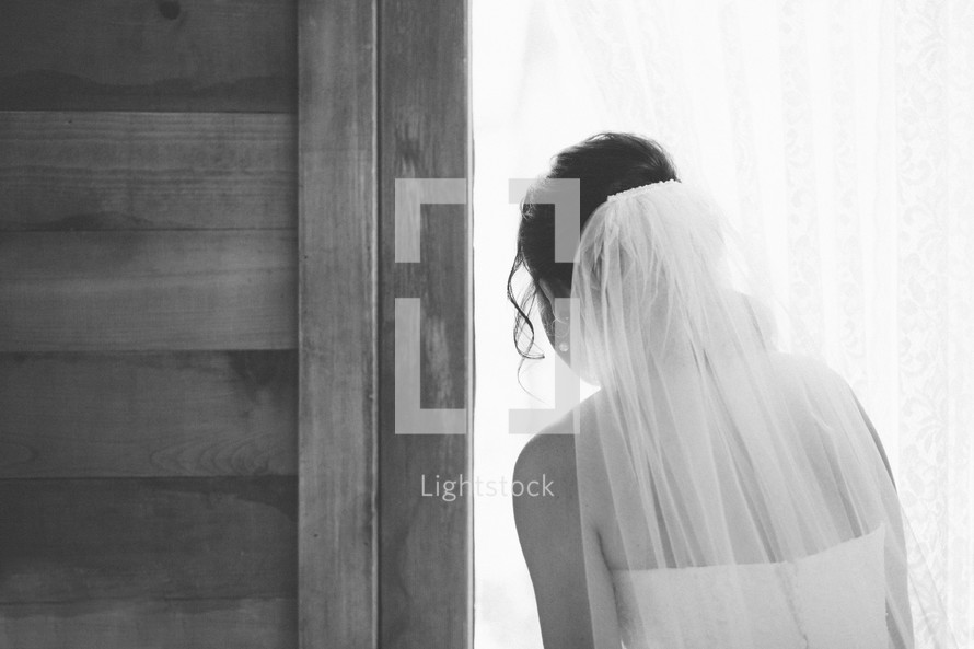 bride looking out a window 