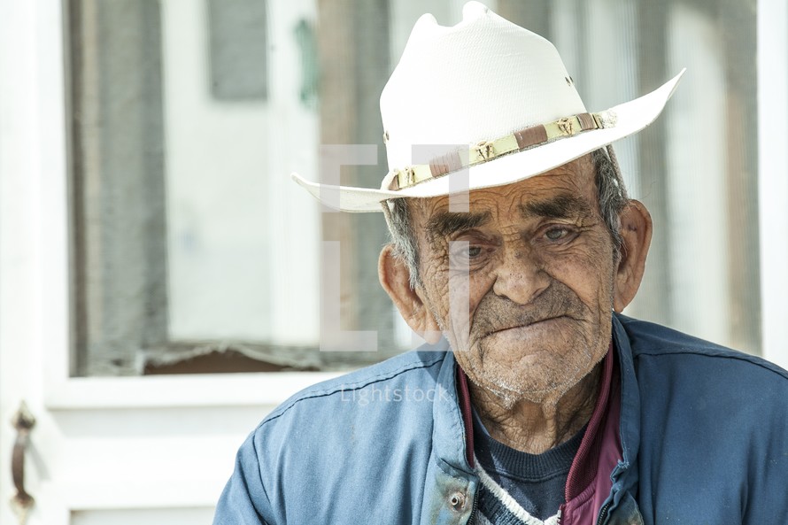 elderly man in a cowboy hat 