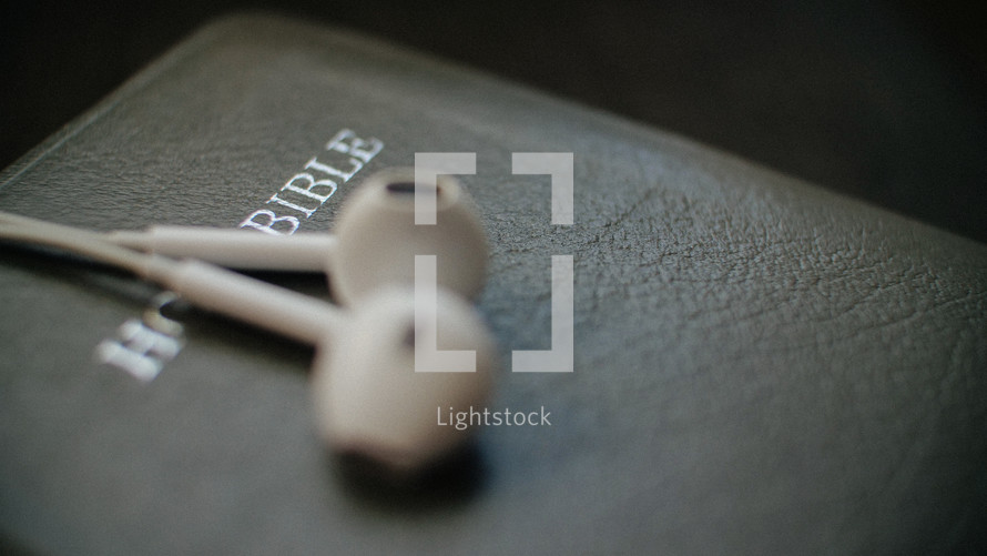 earbuds on a Bible 