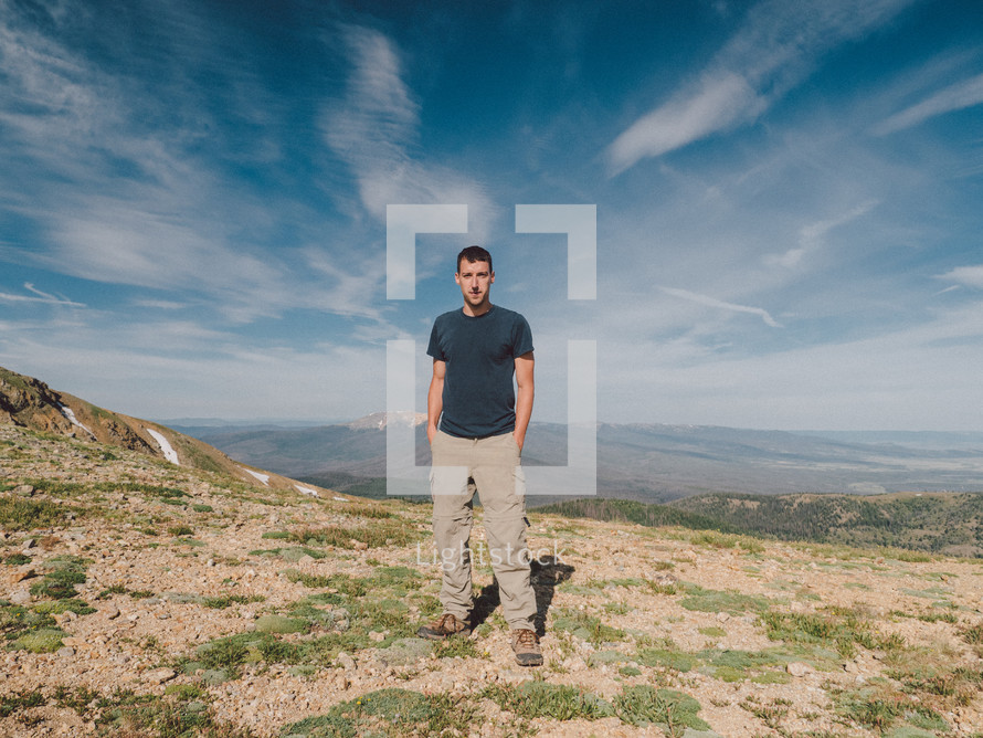 man standing on a mountain top 