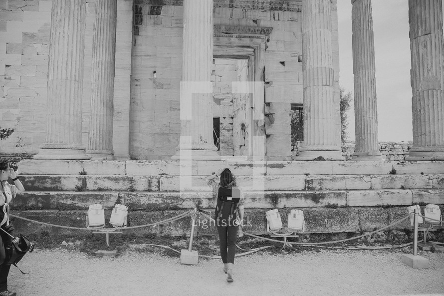 tourist in front of ancient Greek ruins 